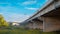 Underneath the elevated Expressway concrete structure, greenery, and clear blue skies landscape view