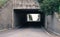 Underpass with trees and foliage in background