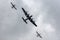 Underside of a Lancaster bomber with a hurricane and spitfire flying beside it taken from below