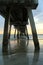 Underside of long fishing pier in early morning sunrise