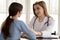 Understanding caring female doctor supporting worried anxious young woman patient