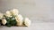 Understated Elegance: White Roses on Chalk Background with Logo Space