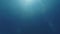 Underwater background with blinking sun rays in blue water