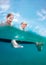 Underwater camera view on two happy smiling children sitting on