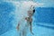 Underwater child jumps to swimming pool