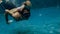 Underwater. father and his daughter swim in the pool on dad`s day