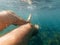 Underwater foot male swimmer on vacation in sea