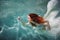 Underwater girl. Beautiful red-haired woman in a white dress, swimming under water.