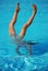 Underwater handstand with feet above the water