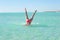 Underwater handstand young woman beach