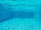 Underwater image of an outside swimming pool in sunshine