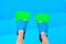 Underwater kids legs in fins in swimming pool, top view. Mockup with copy space