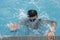Underwater little boy in swimming pool with goggles