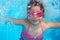 Underwater little girl blue swimming pool