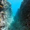 Underwater narrow passage rocky reef Pacific ocean