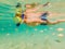 Underwater nature study, boy snorkeling in clear blue sea