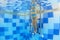 Underwater photo of a child on swimming pool stairs