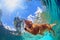 Underwater photo of dog swimming in outdoor pool