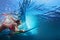 Underwater photo of surfer girl diving under ocean wave