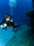 Underwater Photographer looking at a Sunken Ship