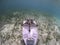 Underwater photography of Starfish on pink fin. Indonesia.