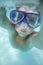 Underwater portrait of child diving in mask