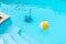 Underwater Robot cleaning a swimming pool and a inflatable ball floating