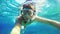 Underwater selfie, man dive in snorkeling diving mask and snorkel in the clear blue sea water.