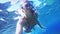 Underwater selfie, woman dive in snorkeling diving mask and snorkel in the clear blue sea water.