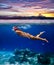 Underwater shoot of a young woman snorkeling in a tropical sea a