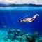 Underwater shoot of a young woman snorkeling in a tropical sea a