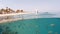 Underwater surface split view of coral fish and resort beach wit