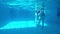 Underwater video of young friends in swimming pool