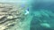 Underwater view of friends snorkeling together in sea water