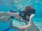 Underwater Young Boy Fun in the Swimming Pool with Goggles. Summer Vacation Fun