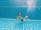 Underwater Young Boy Fun in the Swimming Pool with Goggles. Summer Vacation Fun