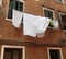 Underwear drying on a rope in the old yard in Italy