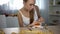 Underweight girl measuring piece of cake with tape, fear of gaining weight