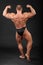 Undressed bodybuilder shows muscles