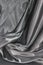 Undulating folds of the fabric of gray silk