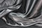 Undulating folds of the fabric of gray silk