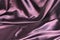 Undulating folds of the fabric of purple silk