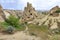 An unearthly landscape and a view of ancient dwellings in ancient cone-shaped caves in the valleys of Cappadocia