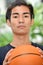 Unemotional Asian Person With Basketball