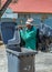 Unemployed black man digging in refuse bin