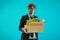 Unemployed Business worker carrying a packed box with upset expression for unemployment concept on blue background