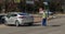 Unemployed caucasian parking attendant assisting motorists