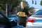 Unemployed panhandler man at traffic intersection with Job Wanted sign