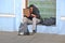 unemployed tired sleeping young man in black suit asking for money for ticket and food in Kiev, Ukraine,