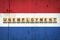 Unemployment. The inscription on wooden blocks on the background of the Netherlands flag. Unemployment growth. Business